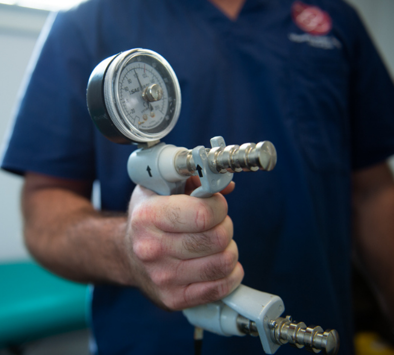 VHC specialist holding a Hydraulic Hand Dynamometer